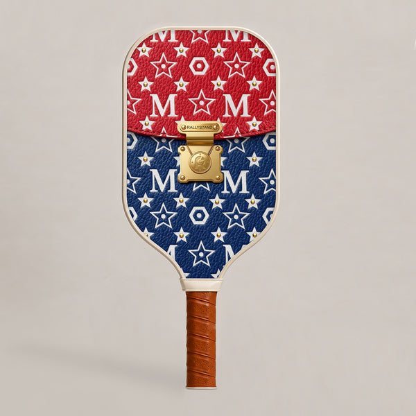 Front view of a luxury RallyStand pickleball paddle featuring a college red, white, and blue designer handbag aesthetic with gold hardware accents.